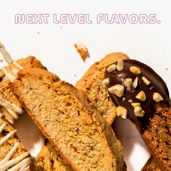 Assortment of biscotti, some drizzled with white chocolate, others dipped in dark chocolate with nuts.