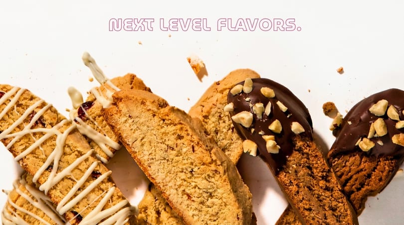 Assortment of biscotti, some drizzled with white chocolate, others dipped in dark chocolate with nuts.